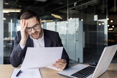 man, paperwork, laptop